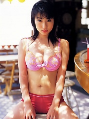 Nonami Takizawa lies on her stomach to show off her cleavage